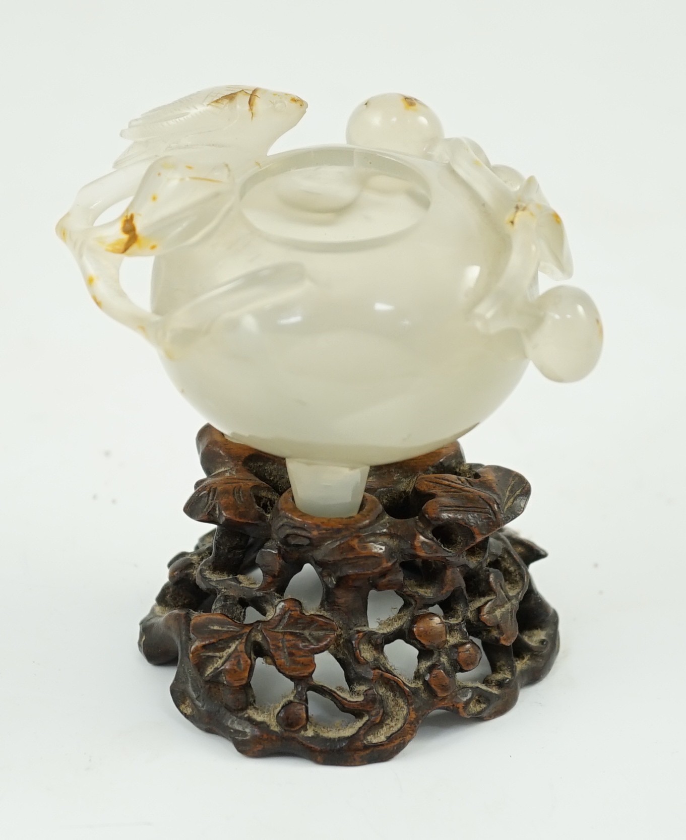 A Chinese small carved agate brushwasher on wooden stand, 19th century, 8.5cm high including stand